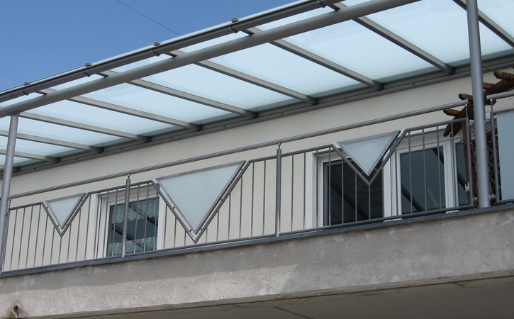 Balkongeländer und Überdachung verzinkt und lackiert, Füllung aus VSG Glas mit mattweißer Folie