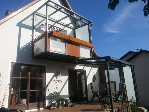 Abgehängter Stahlbalkon mit Terrassenüberdachung verzinkt und lackiert, Balkonfüllung VSG TVG Glas und Cortenstahl