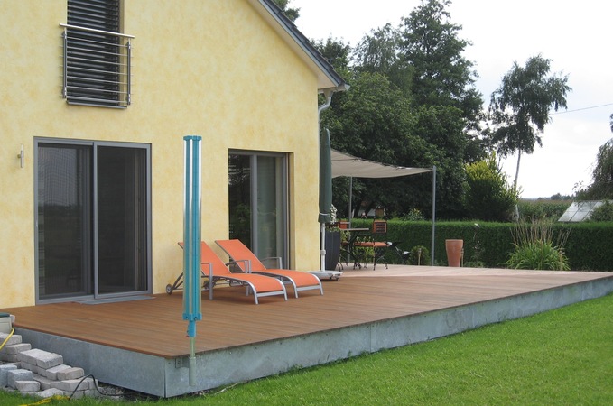 Terrasse: Unterkonstruktion Stahl verzinkt; Belag: Tropenholz Garappa; Beschattung: 3 Stahls&auml;ulen, mit                            Edelstahlseilen von der Wand zu den S&auml;ulen gespannt, mit Segeltuch.