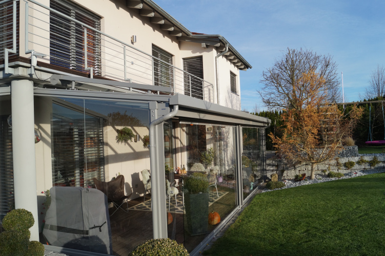 Terrassenüberdachung mit aussenliegender Dach- und Wand- Markise. Glasschiebewand mit bodenebener Führungsschiene zum kompletten öffnen der Glaswand