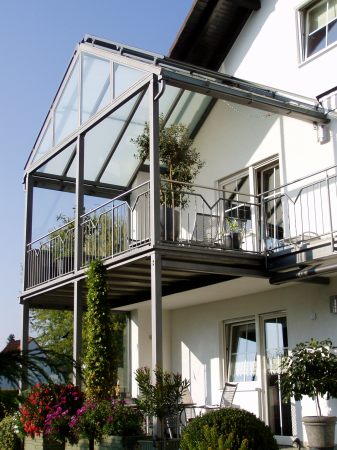 Balkonanbau mit verglaster Überdachung, seitlichem Windschutz,                              Sonnenrollo, Geländer mit Edelstahlhandlauf